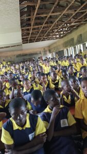 Students gathered in a school hall receiving health education